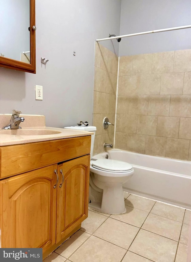bathroom featuring tile patterned flooring, toilet,  shower combination, and vanity