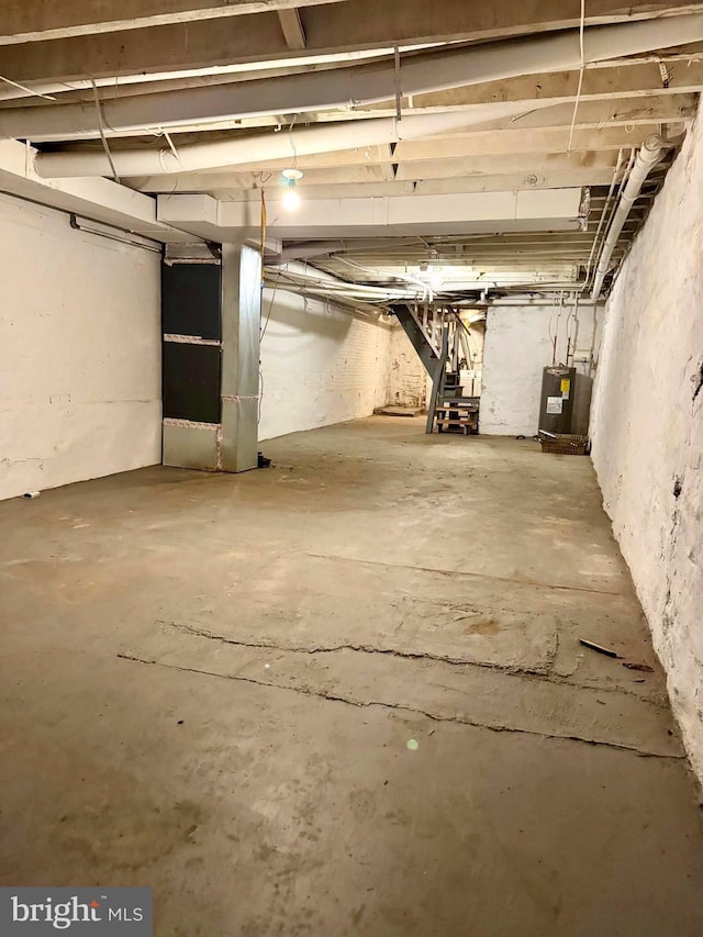 unfinished below grade area featuring water heater