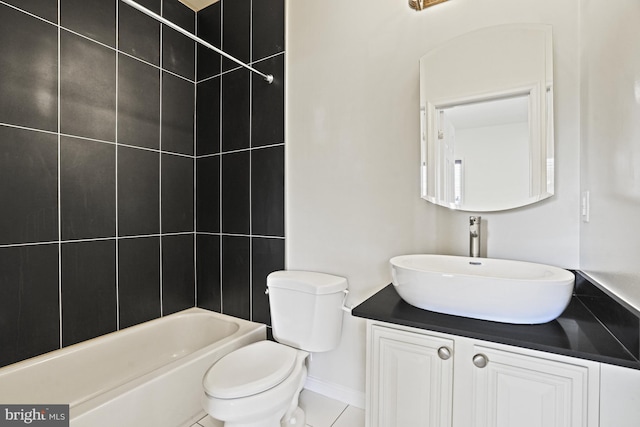 full bathroom featuring toilet, tile patterned floors, tiled shower / bath, and vanity