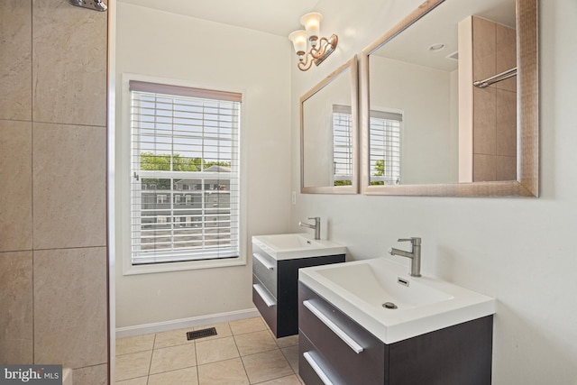 bathroom featuring a wealth of natural light, tile patterned floors, and vanity