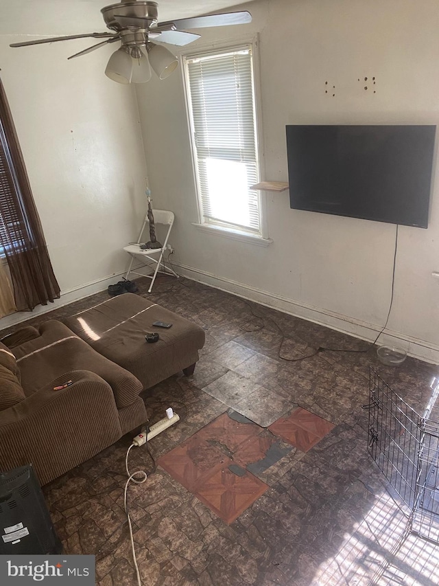 interior space featuring ceiling fan and baseboards