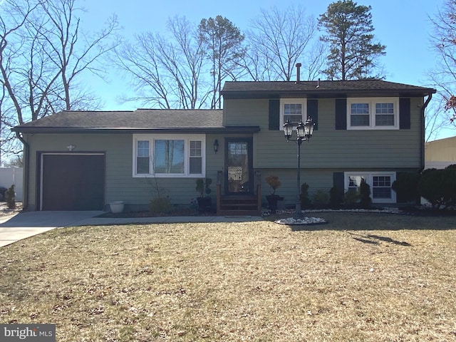 tri-level home featuring concrete driveway and an attached garage