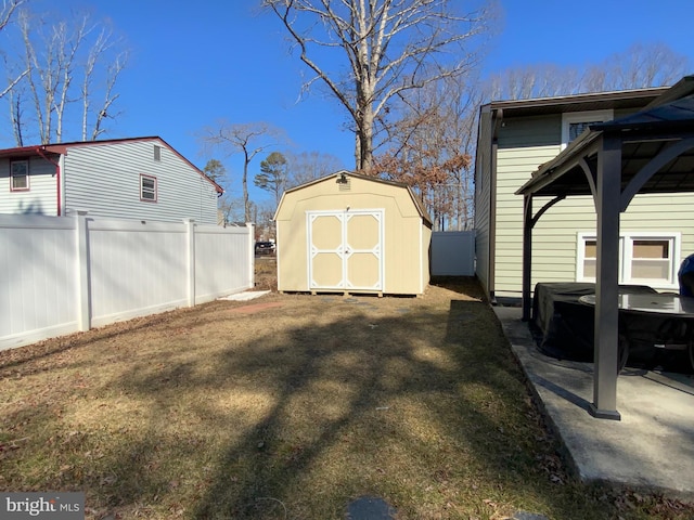 view of yard with an outbuilding, a shed, and fence