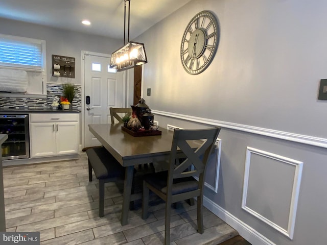 dining area featuring recessed lighting, wine cooler, and wood finish floors