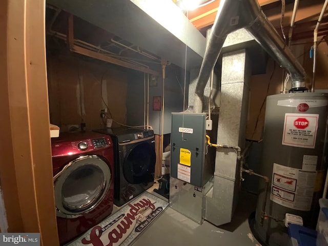 utility room with water heater and separate washer and dryer