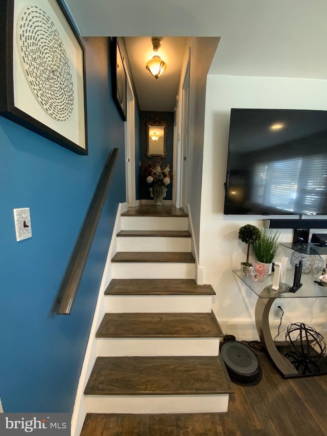 stairway with wood finished floors