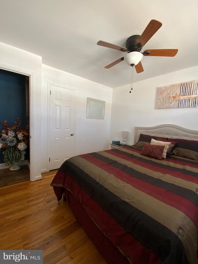 bedroom featuring a ceiling fan and wood finished floors