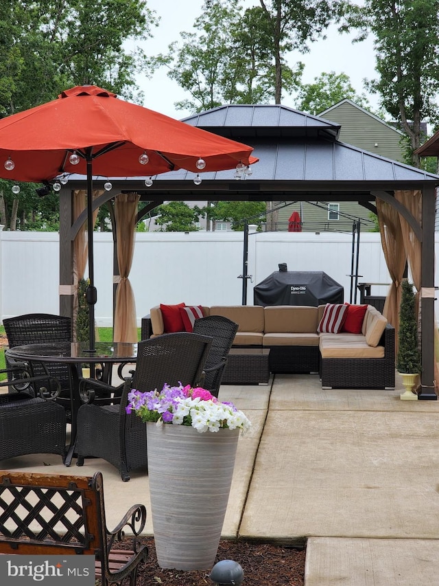 wooden terrace with a patio, outdoor lounge area, fence, a gazebo, and outdoor dining space