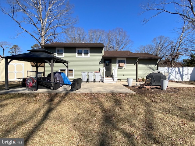 back of house featuring entry steps, a patio, and fence