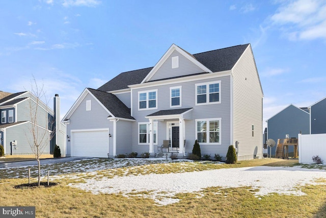 traditional-style home with a garage, driveway, and a residential view