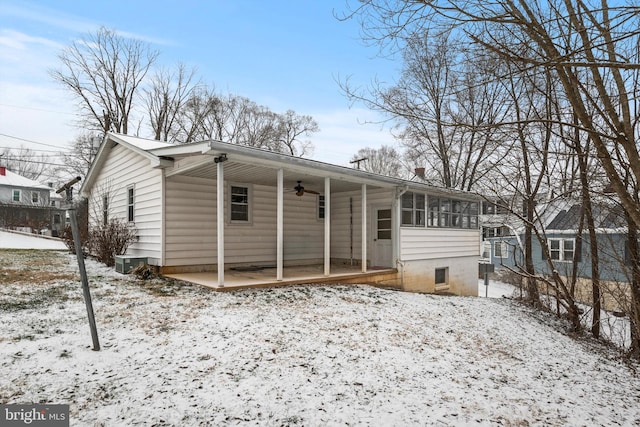 view of front of home with ceiling fan and a sunroom