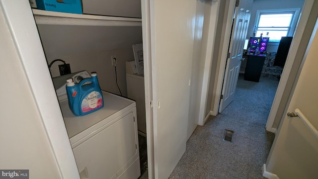 clothes washing area with carpet and washer / dryer