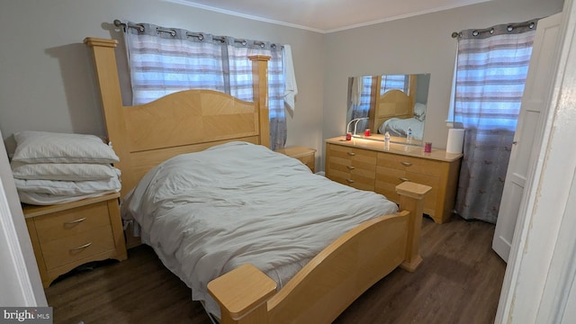 bedroom with dark hardwood / wood-style flooring and crown molding