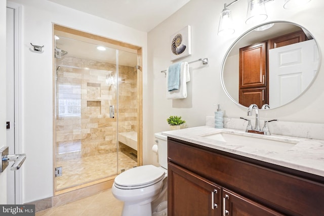 bathroom with toilet, tile patterned flooring, vanity, and a shower with door