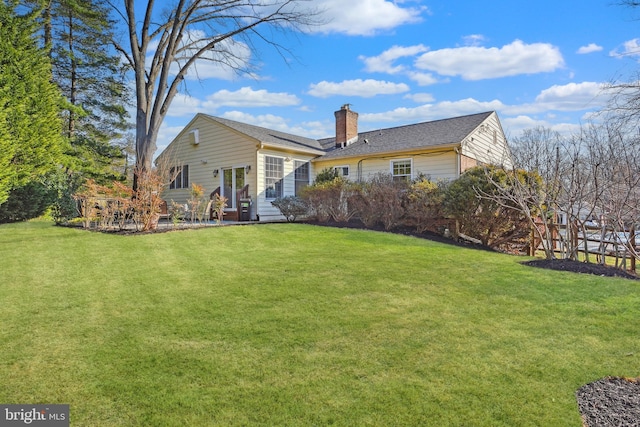 back of property featuring a lawn