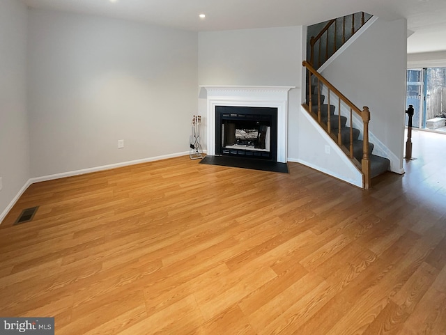 unfurnished living room with light hardwood / wood-style floors