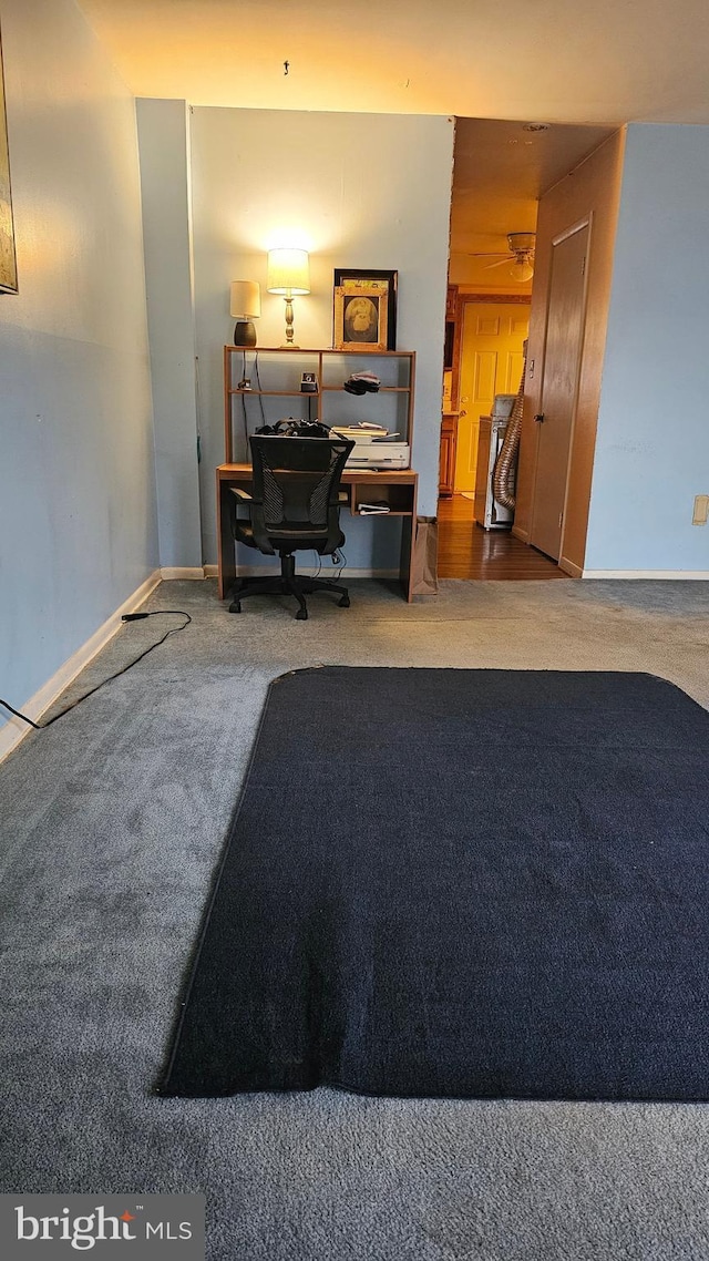 home office featuring carpet flooring and baseboards