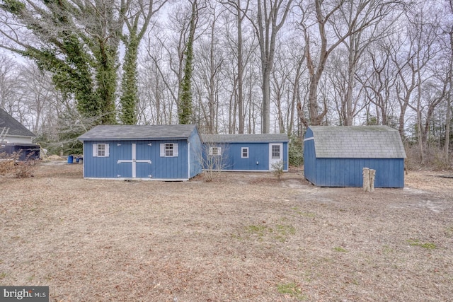 view of front of house featuring a storage unit