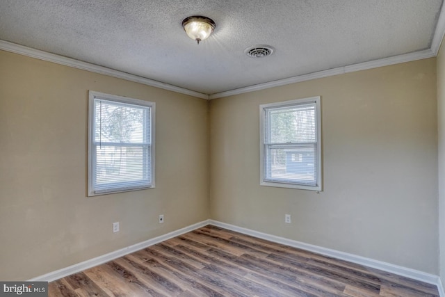 unfurnished room with ornamental molding, wood-type flooring, and a textured ceiling