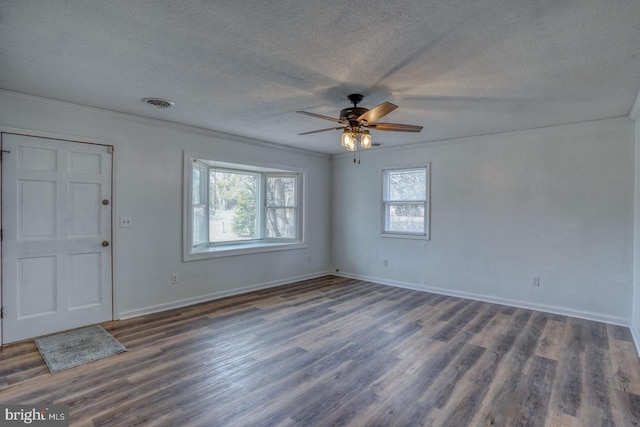 entryway with a textured ceiling, dark wood-type flooring, crown molding, and ceiling fan