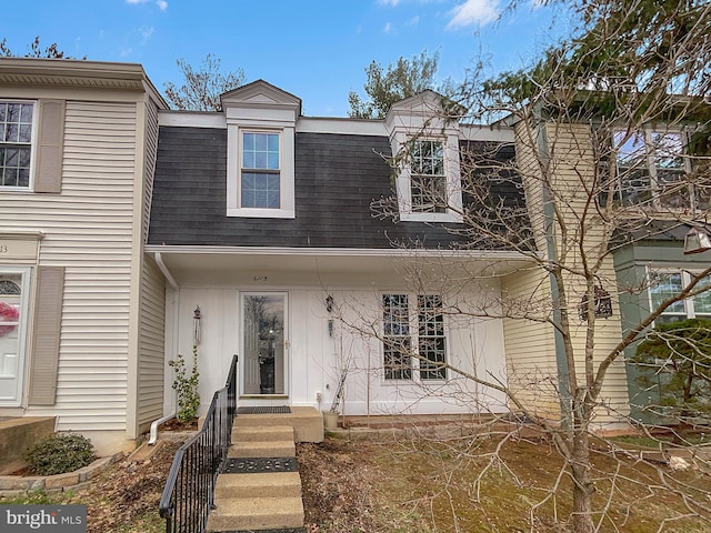 view of property featuring a shingled roof