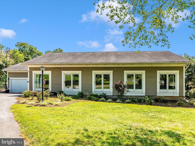 single story home with a front lawn and a garage