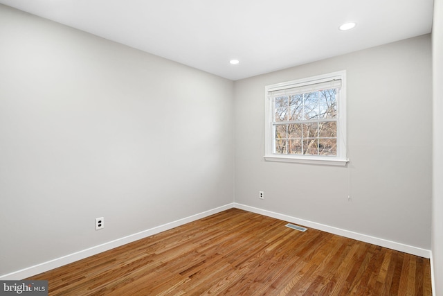 spare room featuring hardwood / wood-style floors