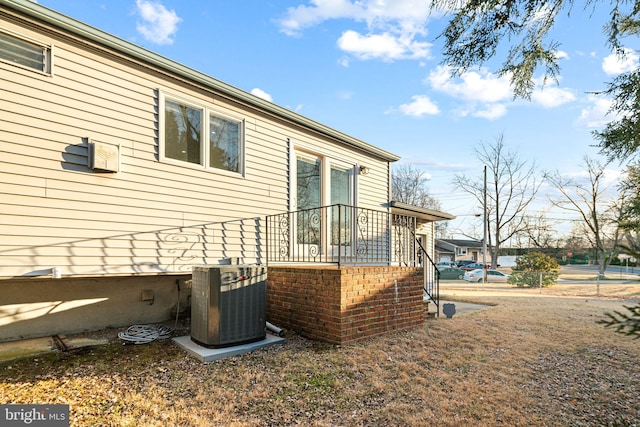 view of side of property with central air condition unit