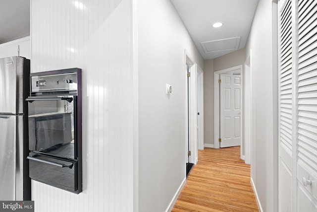 hall with light hardwood / wood-style floors