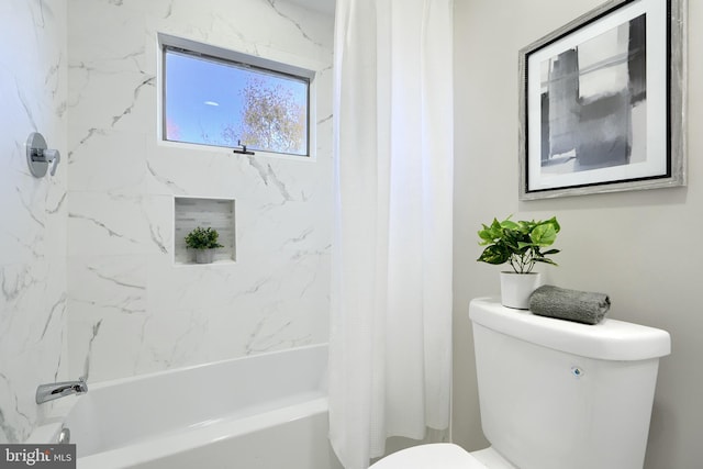 bathroom featuring shower / bath combo with shower curtain and toilet