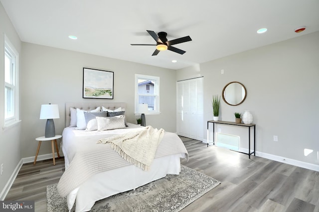 bedroom with hardwood / wood-style flooring, ceiling fan, and a closet