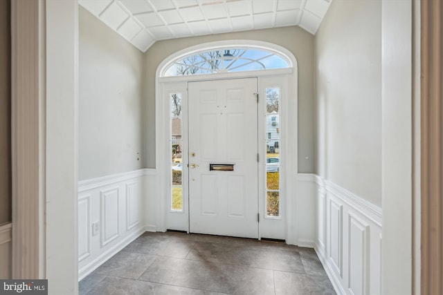 foyer with lofted ceiling and plenty of natural light