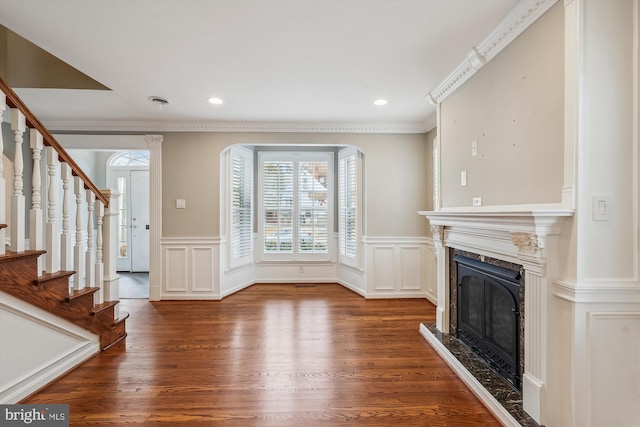 unfurnished living room with ornamental molding, hardwood / wood-style floors, and a premium fireplace