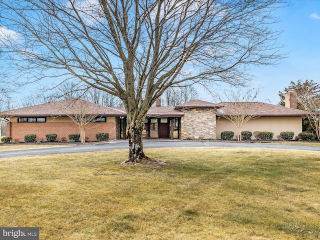 view of front of house featuring a front lawn and a chimney