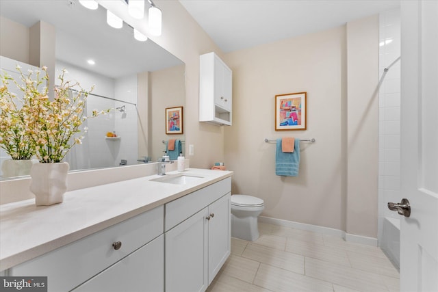 bathroom with baseboards, vanity, toilet, and walk in shower