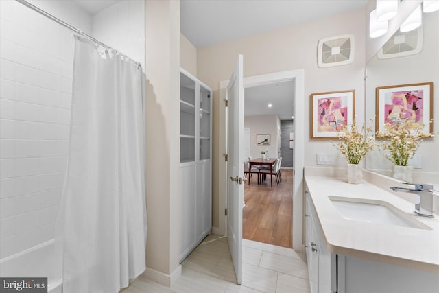 bathroom with tile patterned flooring, vanity, and a shower with curtain