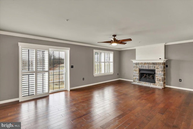 unfurnished living room featuring dark wood-style floors, ornamental molding, and baseboards