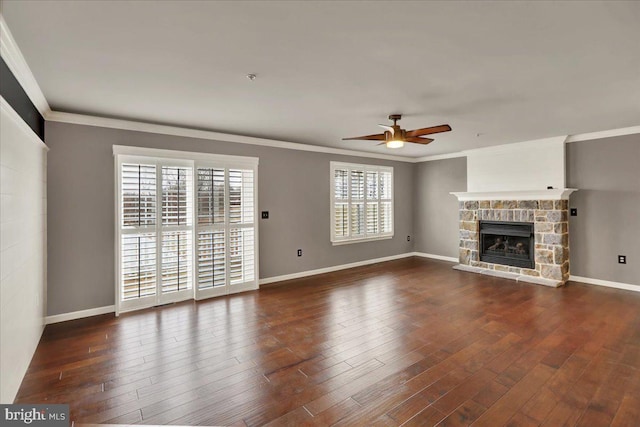 unfurnished living room featuring dark wood-style floors, baseboards, a fireplace, and ornamental molding