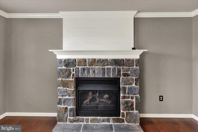 details featuring ornamental molding, a fireplace, wood finished floors, and baseboards