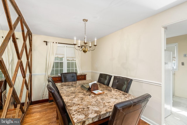 6510 Oakwood Dr, Falls Church, VA 22041 - dining room with baseboards, an inviting chandelier, and wood finished floors