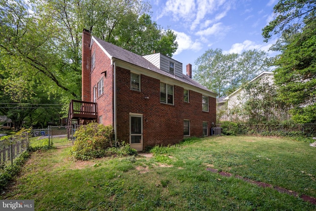 6510 Oakwood Dr, Falls Church, VA 22041 - view of side of property featuring a chimney, a lawn, brick siding, cooling unit, and a fenced backyard