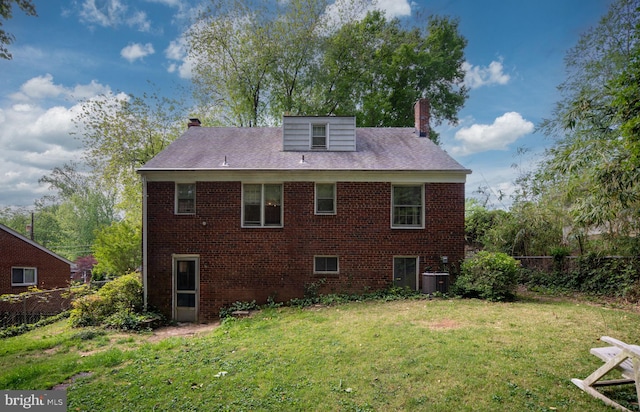 6510 Oakwood Dr, Falls Church, VA 22041 - back of property featuring brick siding, fence, a chimney, and a lawn