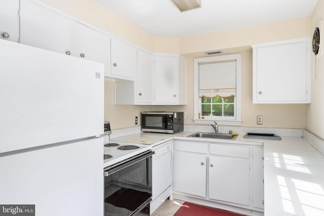 6510 Oakwood Dr, Falls Church, VA 22041 - kitchen featuring a sink, white cabinets, visible vents, white appliances, and light countertops