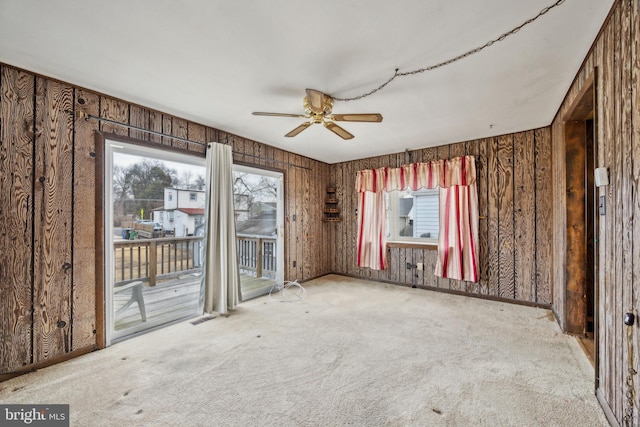 carpeted empty room featuring ceiling fan