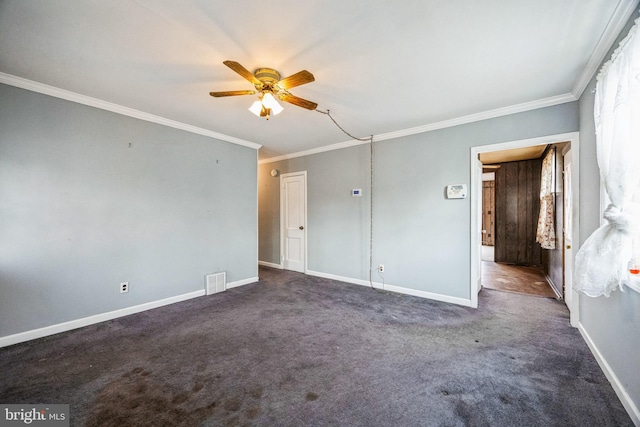 unfurnished bedroom with ornamental molding, dark carpet, and ceiling fan