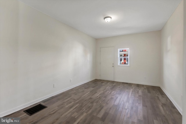 spare room featuring dark hardwood / wood-style flooring