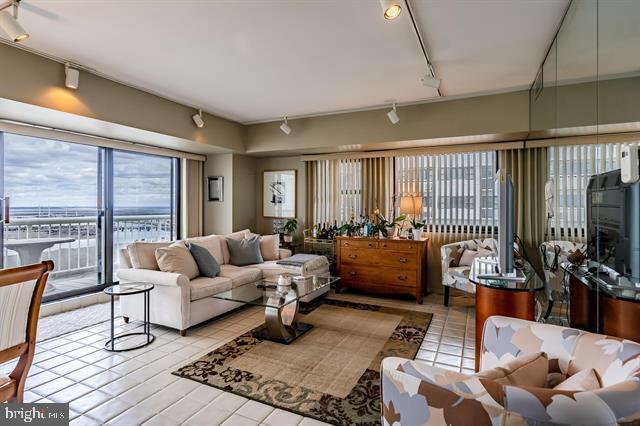 living room featuring track lighting and light tile patterned floors