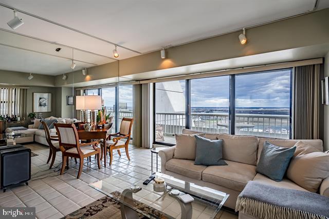 living room featuring light tile patterned floors and rail lighting