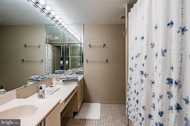 bathroom with vanity, tile patterned flooring, and walk in shower