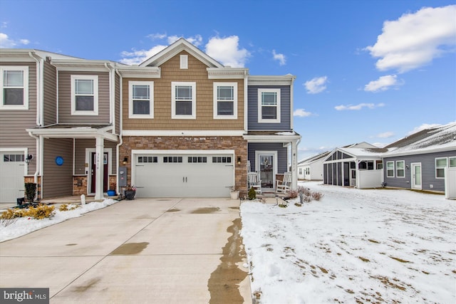 townhome / multi-family property featuring driveway and an attached garage